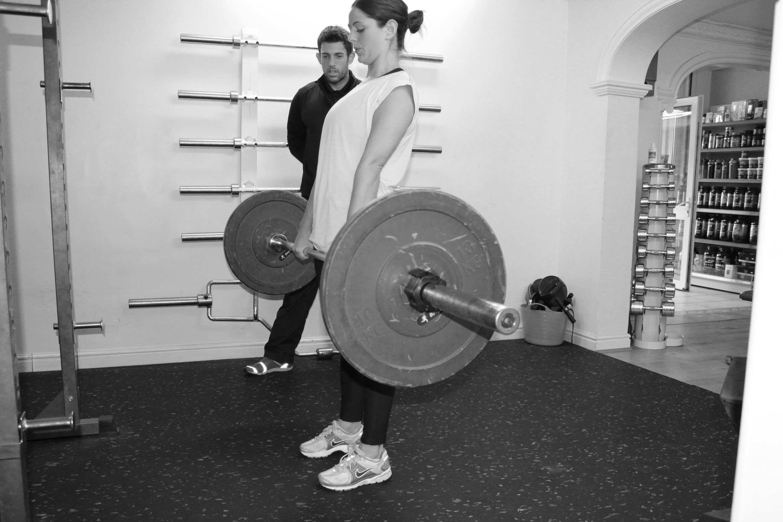 picture of personal trainer with client deadlifts