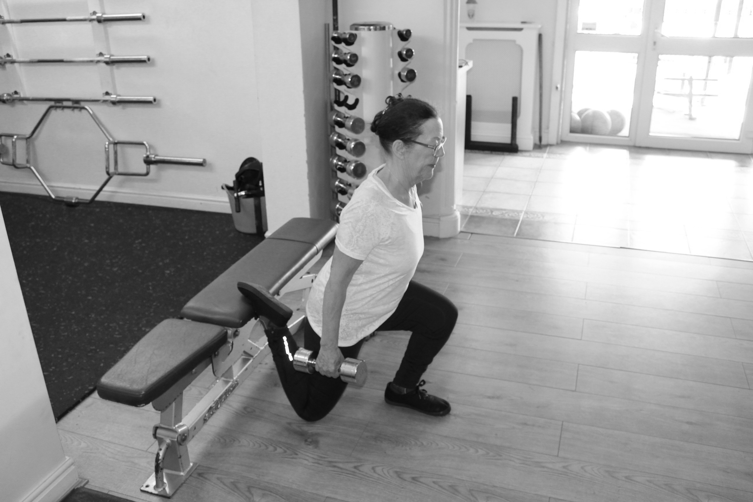 picture of personal trainer with client on bench