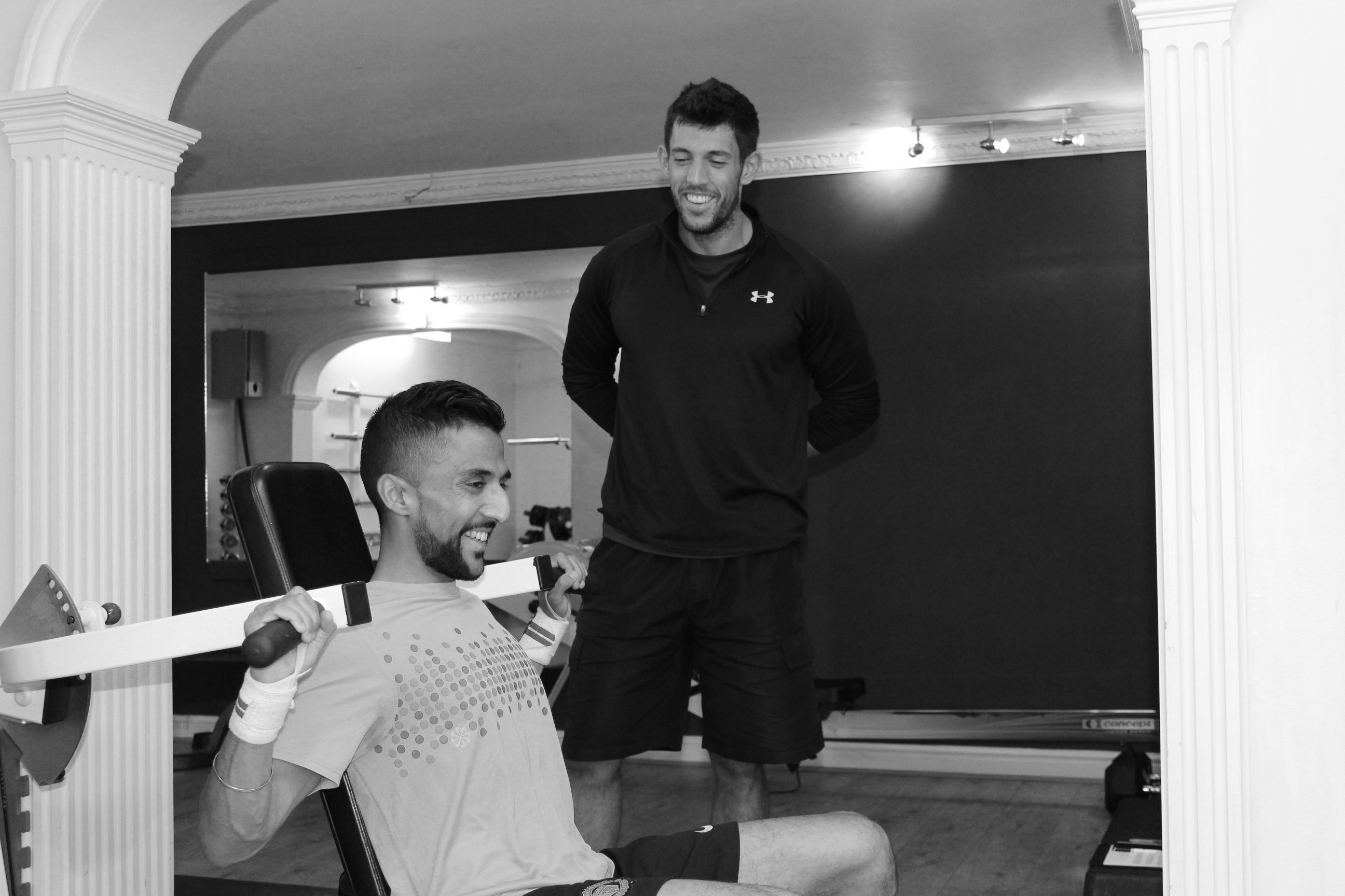 picture of personal trainer with client shoulder press